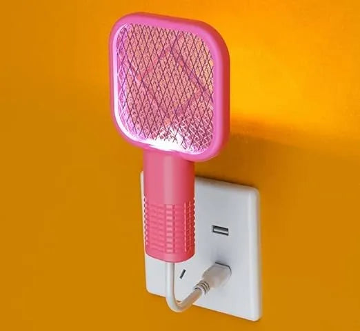 Pink electronic device plugged into a wall socket on an orange background