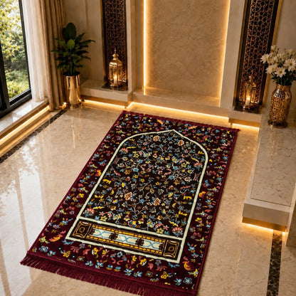 A rectangular Islamic prayer rug with a dark navy and burgundy floral pattern, laid out on a polished beige marble floor in a luxurious room with warm ambient lighting.