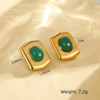 Gold earrings with green stones on a beige background, showing measurements and weight.