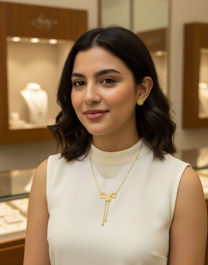 Woman wearing a gold necklace in a jewelry store setting