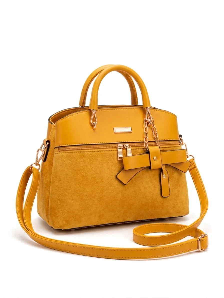 Wonder Mart Elara Bow Luxe Handbag featuring premium soft leather finish, elegant bow design, three spacious compartments, gold hardware, and adjustable shoulder strap......