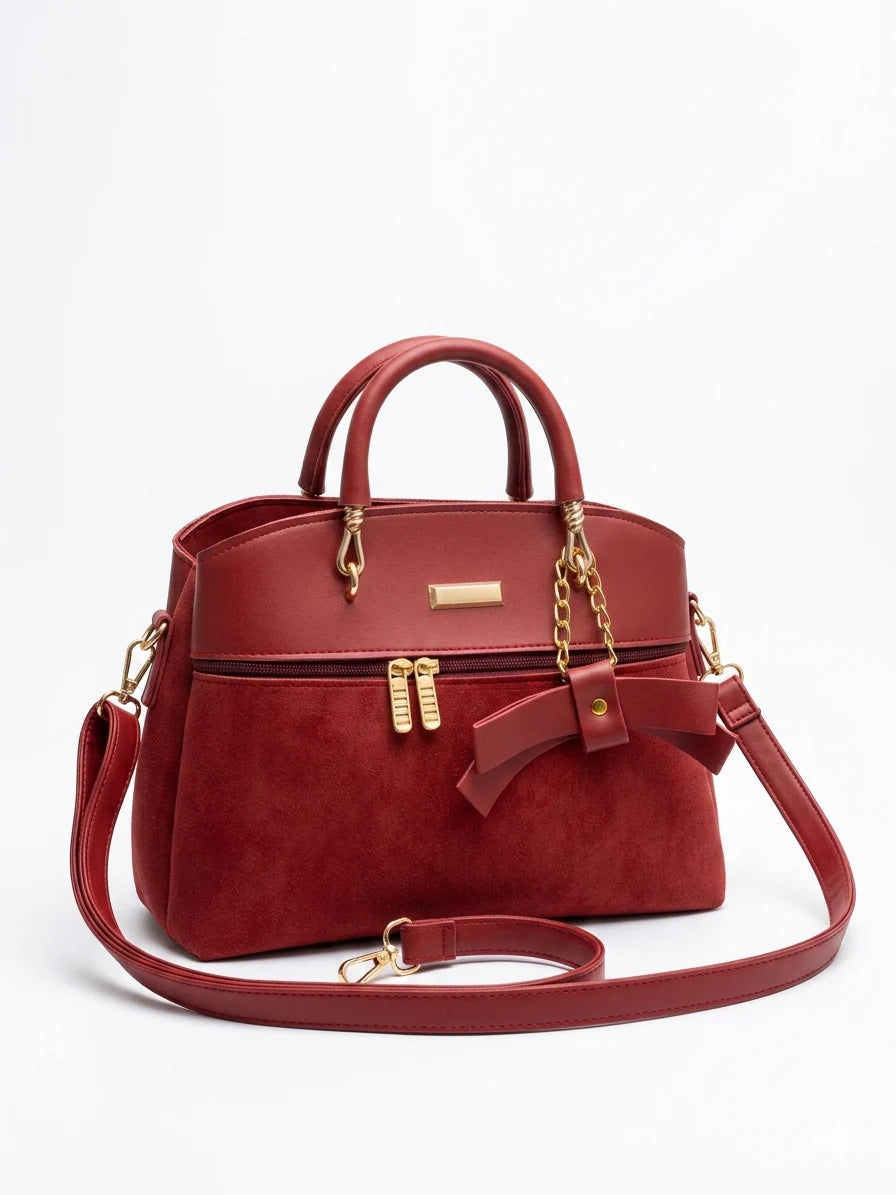 Wonder Mart Elara Bow Luxe Handbag featuring premium soft leather finish, elegant bow design, three spacious compartments, gold hardware, and adjustable shoulder strap..