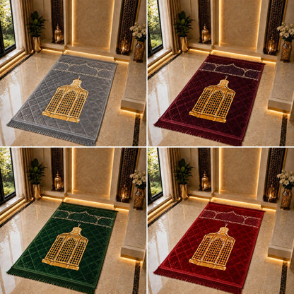 Four prayer rugs shown in a 2x2 grid, each in a different color: gray, burgundy, green, and red. Each rug features a large gold bird-of-paradise design in the center with gold geometric border details and a fringed edge.